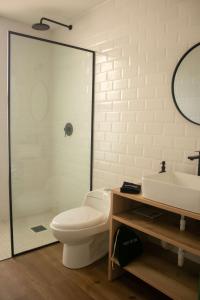 a bathroom with a toilet and a shower and a sink at Avani in Contadora