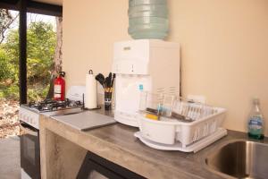 a kitchen counter with a mixer and a sink at Avani in Contadora +48 photos