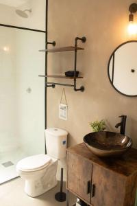 a bathroom with a toilet and a sink at Avani in Contadora