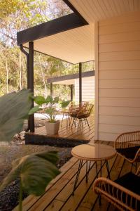 a porch with a table and chairs on it at Avani in Contadora