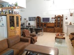 a living room with a couch and a dining room at Castel Ashkelon in Ashqelon