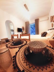 a bedroom with a bed and two bowls on the floor at Chic & Calm apartment 3 minutes walk to Rafina Beach in Rafina