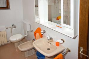 a bathroom with a sink and a toilet and a mirror at Apartments Villa Ada in Vinkuran +45 photos
