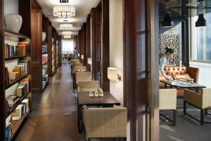 a long corridor with tables and chairs in a library at Mandarin Oriental, Guangzhou in Guangzhou