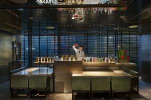 a woman standing behind a counter in a restaurant at Mandarin Oriental, Guangzhou in Guangzhou +39 photos
