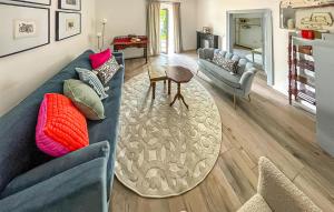 a living room with a blue couch and a table at Ferienhaus Persenbeug in Ybbs an der Donau