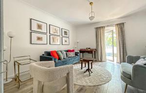 a living room with a blue couch and a table at Ferienhaus Persenbeug in Ybbs an der Donau +13 photos