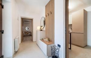a hallway with white walls and a mirror at Awesome Apartment In Muntic With Wifi in Muntić