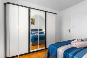 a bedroom with a bed and a mirror at Pool apartman Maja in Šibenik +22 photos