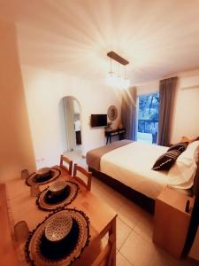 a bedroom with a bed and two hats on a table at Chic & Calm apartment 3 minutes walk to Rafina Beach in Rafina