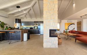 a living room and kitchen with a stone wall at Lovely Home In Jadranovo With Wifi in Jadranovo