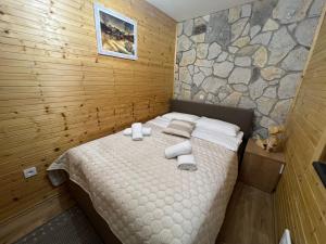 a bedroom with a bed with towels on it at Zen Den apartments in Otočac