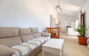 a living room with a couch and a table at Nice Home In Benajarafe With Wifi in Benajarafe