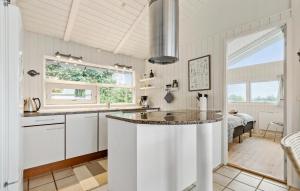 a kitchen with a island in the middle of a room at 3 Bedroom Lovely Home In Ebeltoft in Ebeltoft
