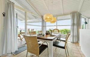 a dining room with a table and chairs at 3 Bedroom Lovely Home In Ebeltoft in Ebeltoft