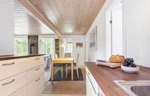 a kitchen with a wooden ceiling and a table at Pet Friendly Home In Kolind With Wifi in Kolind
