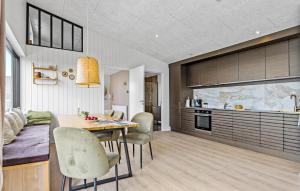 a kitchen and dining room with a table and chairs at 4 Bedroom Gorgeous Home In Sjølund in Sjølund