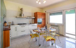a kitchen with a table and chairs in a kitchen at 2 Bedroom Nice Apartment In Orbetello in Orbetello