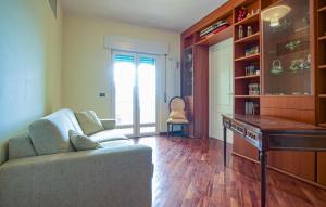 a living room with a couch and a desk at 2 Bedroom Nice Apartment In Orbetello in Orbetello