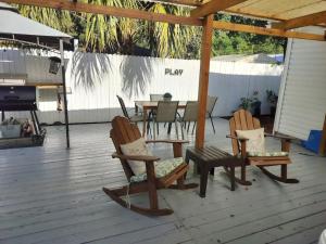 a patio with two chairs and a table and a grill at Charming 4-Bedroom Family Haven in Saint Augustine +37 photos