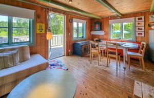 a living room with a couch and a table at 3 Bedroom Cozy Home In Mellerud in Mellerud