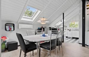 a kitchen and dining room with a table and chairs at Awesome Home In Skjern With Wifi in Skjern
