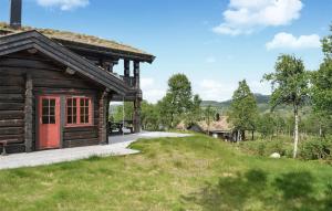 a log cabin with a red door on a hill at Amazing Home In Rauland With Wifi in Rauland +6 photos