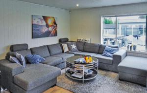 a living room with a couch and a table at Cozy Home In Hellvik With Wifi in Hellvik