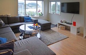 a living room with a couch and a table at Cozy Home In Hellvik With Wifi in Hellvik