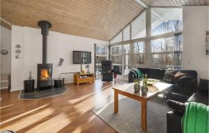 a living room with a fireplace and a couch at Holiday Home Toftlund With A Fireplace 09 in Arrild