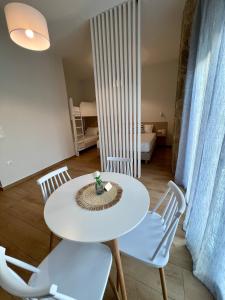 a white table and chairs in a room at mySIVIRI in Siviri +11 photos