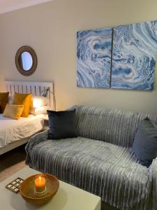 a living room with a couch and a table at Seaside Vacation Studio @ Shearwater Myoli Beach in Sedgefield +42 photos