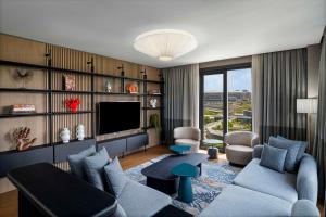 a living room with a couch and a tv at Radisson Residences Vadistanbul in Istanbul