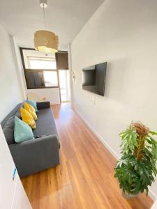 a living room with a couch and a flat screen tv at Apartment Karin in Arona