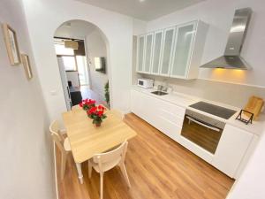 a kitchen with a wooden table and a dining room at Apartment Karin in Arona
