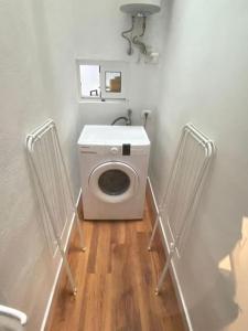 a bathroom with a washing machine in a room at Apartment Karin in Arona