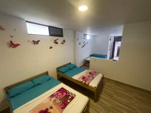 Postel nebo postele na pokoji v ubytování Eco Hotel Campestre Atlantis San Joaquín La Mesa
