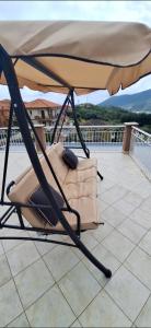 a chair under an umbrella on a roof at Attico Morette, terrazzo - whazapp tre due 0 26 ott ott sei 2 quattro in Boissano