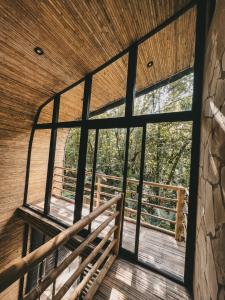 a view from the inside of a building with a large window at Cabaña de Bambú en la Selva in Palenque +8 photos