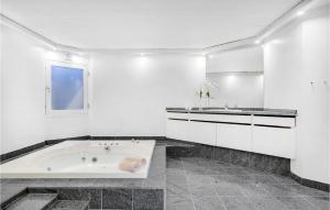 a white bathroom with a tub and a sink at 6 Bedroom Gorgeous Home In Gilleleje in Gilleleje