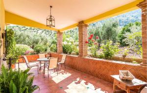 a patio with a table and chairs and a view at Cozy Home In El Gastor in El Gastor +29 photos