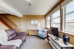 Una sala de estar con un sofá y un televisor. en Seaglass Cottage, en York