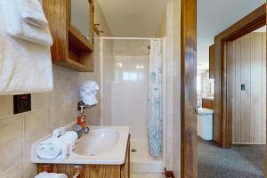 a bathroom with a sink and a shower at Seaglass Cottage in York +39 photos