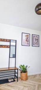 a living room with a mirror and a table at Modern & Convenient Studio in Arnhem
