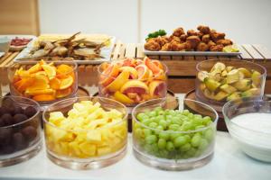a bunch of different types of fruit in glass bowls at Karaksa Hotel Osaka Namba in Osaka +46 photos