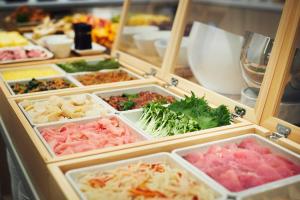 a refrigerator filled with lots of different types of food at Karaksa Hotel Osaka Namba in Osaka
