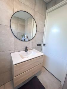 a bathroom with a sink and a mirror at Modern & Convenient Studio in Arnhem