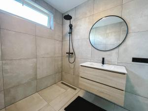 a bathroom with a sink and a mirror at Modern & Convenient Studio in Arnhem +16 photos