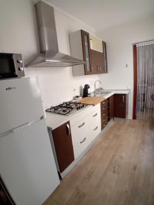 a kitchen with a stove and a white refrigerator at Apartamento Huelva Centro in Huelva