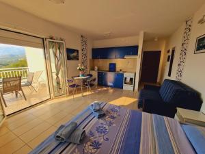 a living room with a bed and a kitchen with a balcony at Vila Natalia in Petrovac na Moru